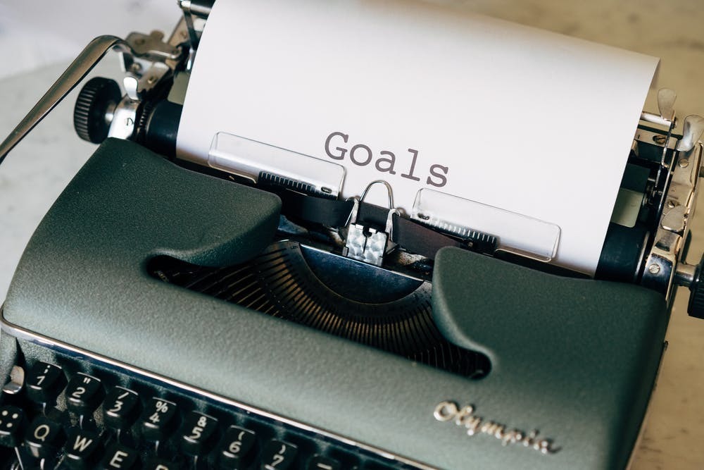 typewriter with paper in it that says goals
