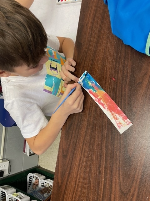 4th grade students painting Valentine bookmarks