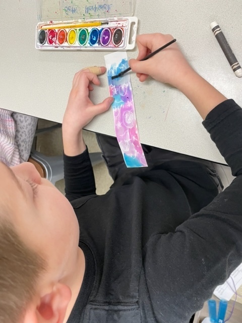 4th graders painting Valentine bookmarks